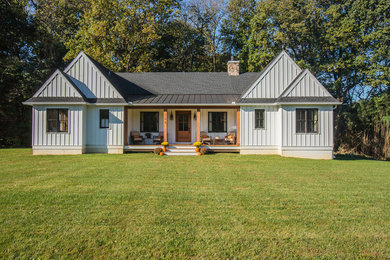 This is an example of a rural detached house in Philadelphia with a pitched roof and a mixed material roof.