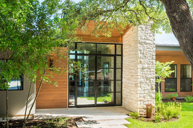 Inspiration for a large contemporary gray two-story mixed siding exterior home remodel in Austin with a shed roof