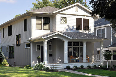 Inspiration for a large transitional white two-story concrete fiberboard exterior home remodel in Minneapolis with a hip roof