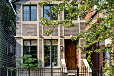 Large elegant red three-story brick exterior home photo in Chicago