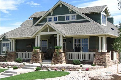 Inspiration for a large craftsman green two-story wood gable roof remodel in New York