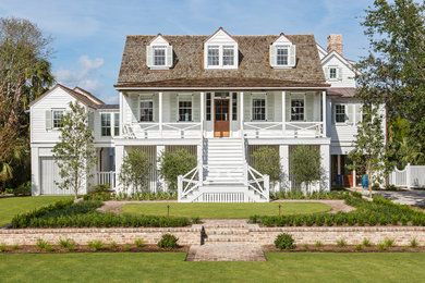 Design ideas for a white beach style detached house in Charleston with three floors, wood cladding, a hip roof and a shingle roof.