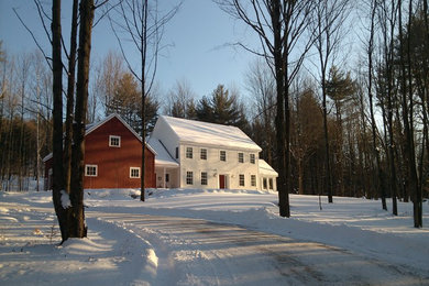 Photo of a white farmhouse two floor house exterior in Burlington with concrete fibreboard cladding and a pitched roof.