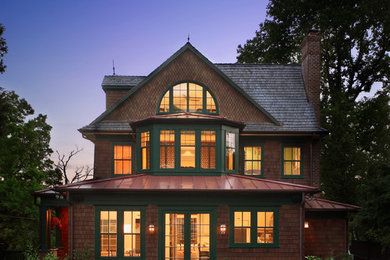 Ornate three-story wood exterior home photo in DC Metro with a shingle roof