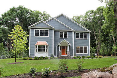 Example of a classic blue two-story mixed siding exterior home design in Boston