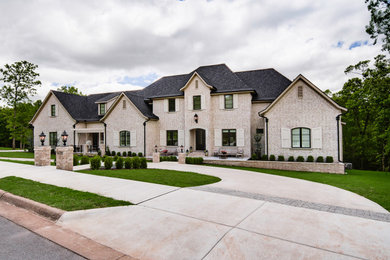 Example of a large transitional three-story brick exterior home design in Little Rock
