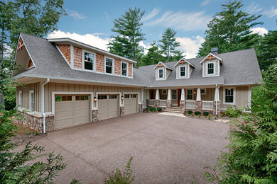 Example of a large arts and crafts beige two-story concrete fiberboard exterior home design in Other with a shingle roof