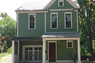 Modelo de fachada verde tradicional renovada de tamaño medio de tres plantas con revestimiento de aglomerado de cemento