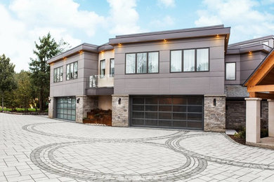 Modelo de fachada de casa gris minimalista extra grande de dos plantas con revestimientos combinados y tejado plano