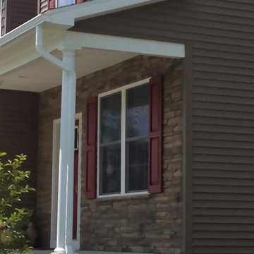 close up of front gutters/downspouts - white to match column