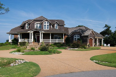 Example of a large beach style two-story wood exterior home design in Other with a shingle roof