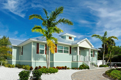 Beach style blue exterior home photo with a metal roof