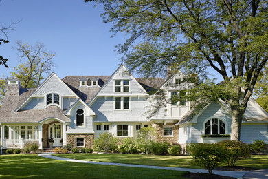 Large traditional blue two-story wood gable roof idea in Chicago
