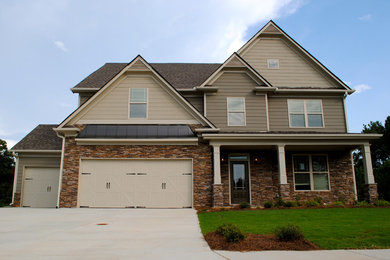 Large craftsman beige two-story mixed siding exterior home idea in Atlanta with a mixed material roof