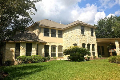 Inspiration for a large timeless beige two-story mixed siding exterior home remodel in Austin with a shingle roof