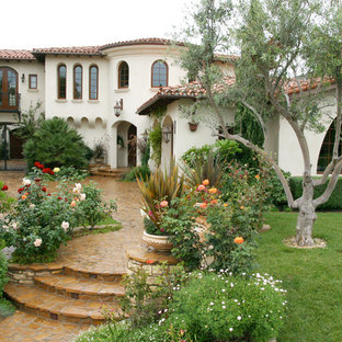 Inspiration for a mediterranean two-story exterior home remodel in Orange County