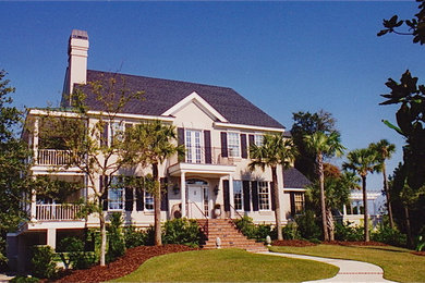 Inspiration for a large timeless beige two-story exterior home remodel in Charleston