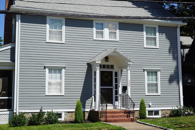 Mid-sized elegant gray two-story concrete fiberboard gable roof photo in Boston with a shingle roof