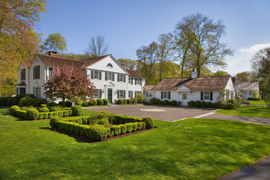Large elegant white two-story wood exterior home photo in New York with a shingle roof