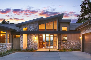 Inspiration for a large contemporary brown one-story stone gable roof remodel in Denver