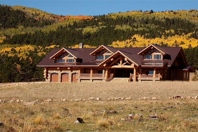 Inspiration for an expansive and brown rustic house exterior in Denver with three floors and wood cladding.