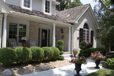Example of a transitional beige brick house exterior design in Omaha