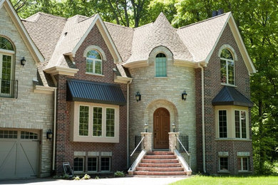 Inspiration for a mid-sized timeless multicolored two-story mixed siding exterior home remodel in Chicago with a shingle roof