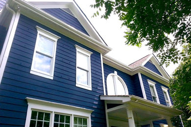 Inspiration for a timeless blue two-story exterior home remodel in Raleigh with a shingle roof