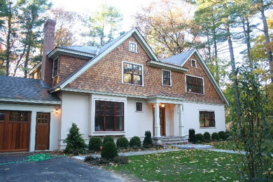 Example of a large beige concrete exterior home design in Boston with a shed roof