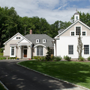 Example of a large farmhouse beige two-story mixed siding exterior home design in New York with a shingle roof