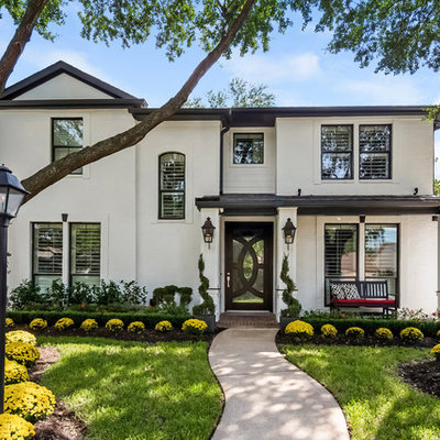 Mid-sized transitional white two-story house exterior idea in Houston with a hip roof and a shingle roof