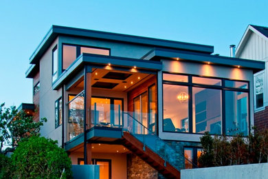 Inspiration for a contemporary gray three-story mixed siding flat roof remodel in Vancouver