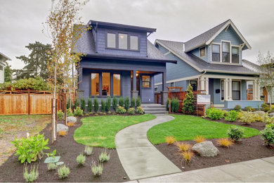 Inspiration for a large craftsman blue three-story wood exterior home remodel in Seattle with a clipped gable roof