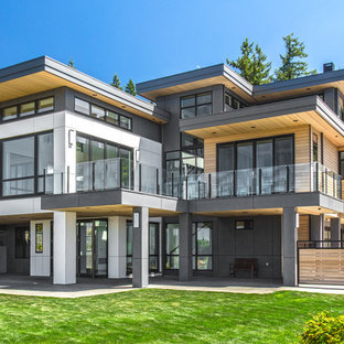 Large trendy multicolored two-story mixed siding exterior home photo in Seattle with a metal roof
