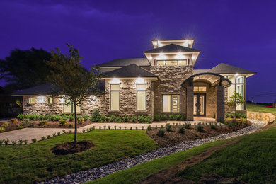 This is an example of a large and beige classic two floor house exterior in Dallas with stone cladding.