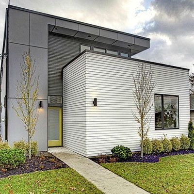 Mid-sized contemporary gray two-story mixed siding flat roof idea in Seattle