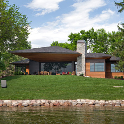 Example of a trendy wood exterior home design in Minneapolis with a hip roof