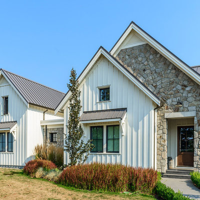 Large cottage white two-story concrete fiberboard exterior home photo in Vancouver with a metal roof