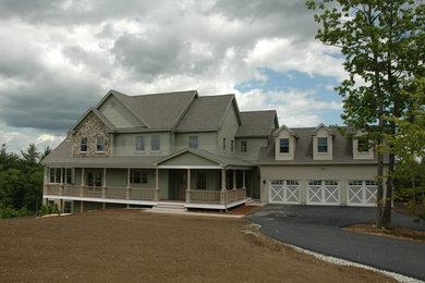 Inspiration for a large cottage green two-story vinyl exterior home remodel in Manchester with a shingle roof