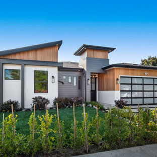 Large contemporary multicolored one-story mixed siding house exterior idea in Los Angeles with a shed roof and a shingle roof