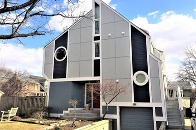 This is an example of a medium sized and blue contemporary detached house in DC Metro with three floors and concrete fibreboard cladding.
