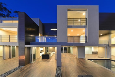 Inspiration for a large contemporary gray three-story flat roof remodel in San Diego