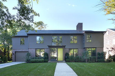 Inspiration for a contemporary brown two-story vinyl exterior home remodel in New York with a shingle roof
