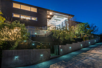 Contemporary multicolored two-story stucco flat roof idea in Los Angeles