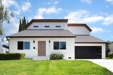 Example of a mid-sized transitional white two-story house exterior design in Los Angeles with a shingle roof