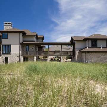 Contemporary Prairie Lake House, in Stucco and Stone, with Covered Walkway