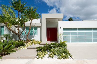 This is an example of a medium sized and white contemporary bungalow concrete house exterior in Other.