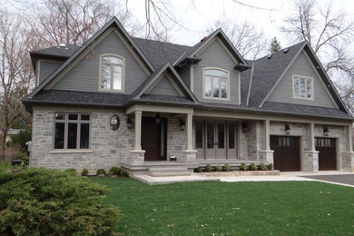 Large ornate gray two-story mixed siding house exterior photo in Toronto