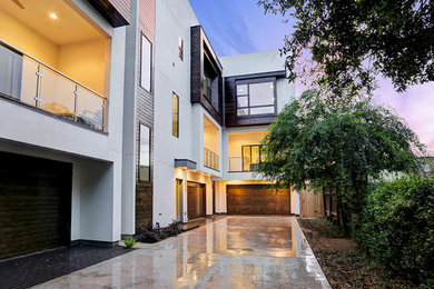 Inspiration for a large contemporary white three-story mixed siding flat roof remodel in Houston