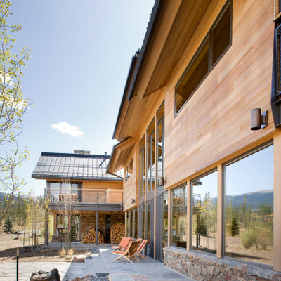 Large minimalist brown two-story mixed siding exterior home photo in Denver
